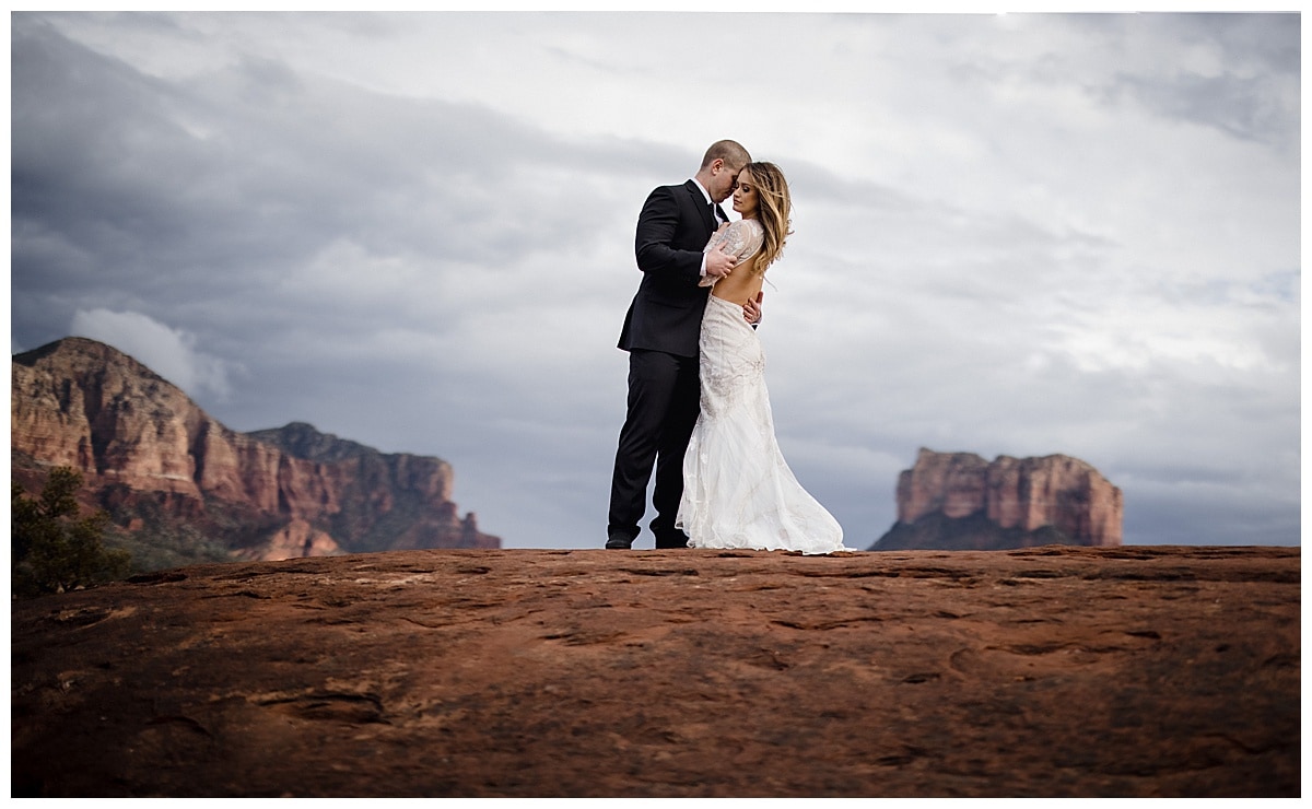 cathedral rock bride and groom, groom holding bride in sedona elopement