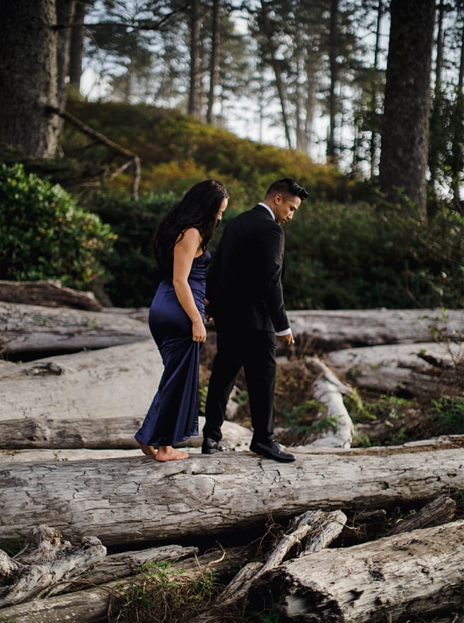 Couple balancing on drift wood for their Ruby Beach Engagement Photoshoot