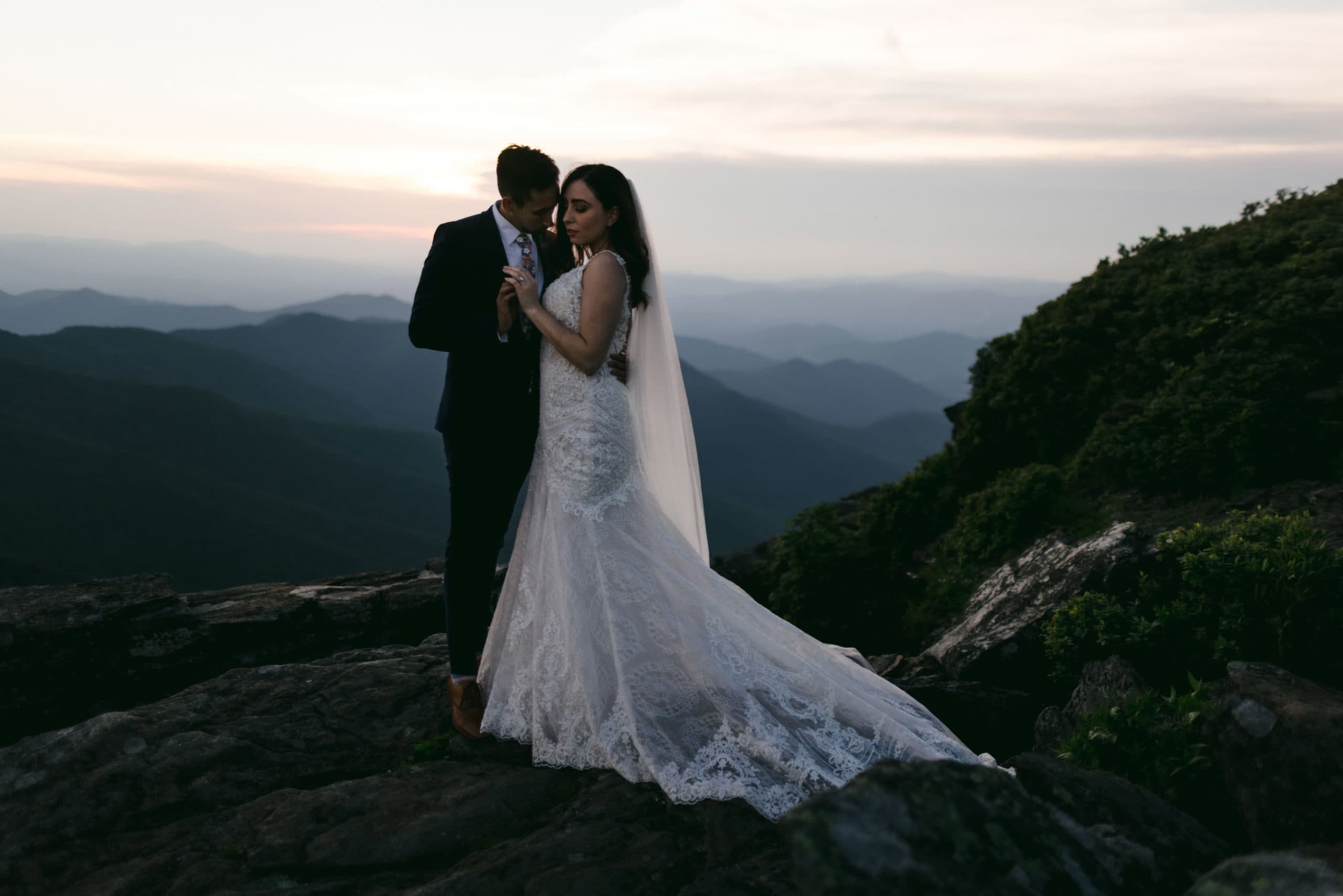 Bride and groom on a mountain after hiring their Colorado elopement photographer