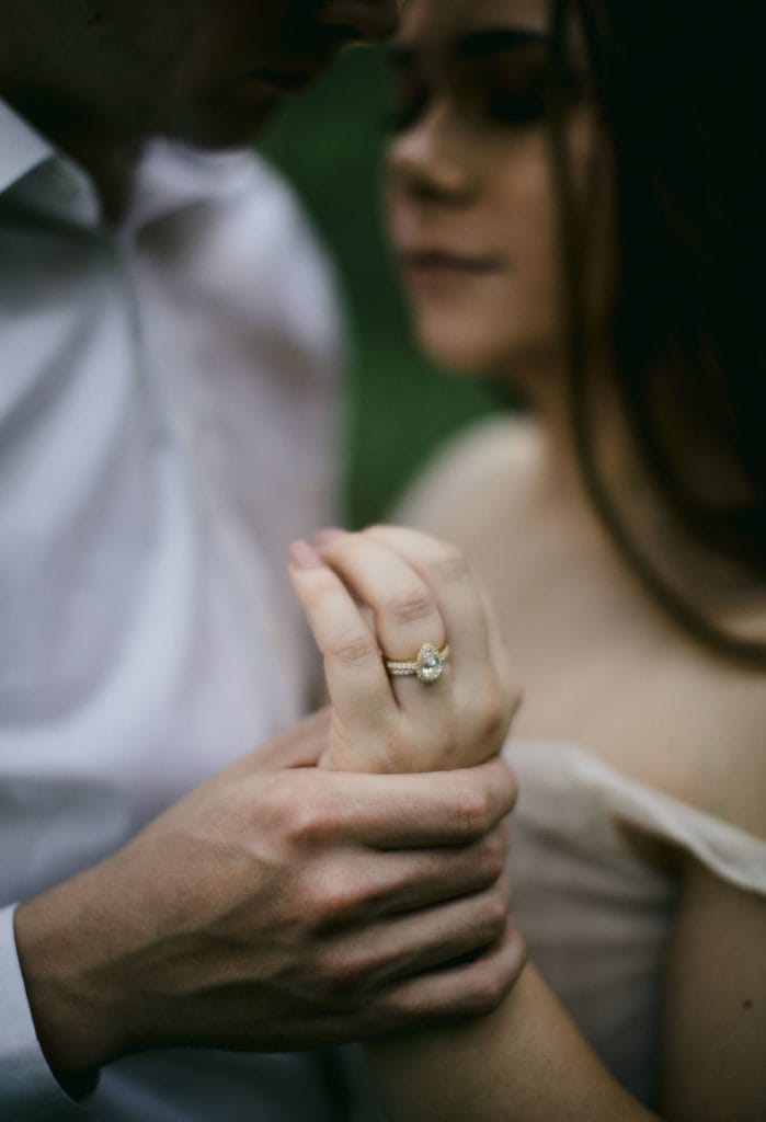 Couple in the forest embracing after their vow renewal ceremony.