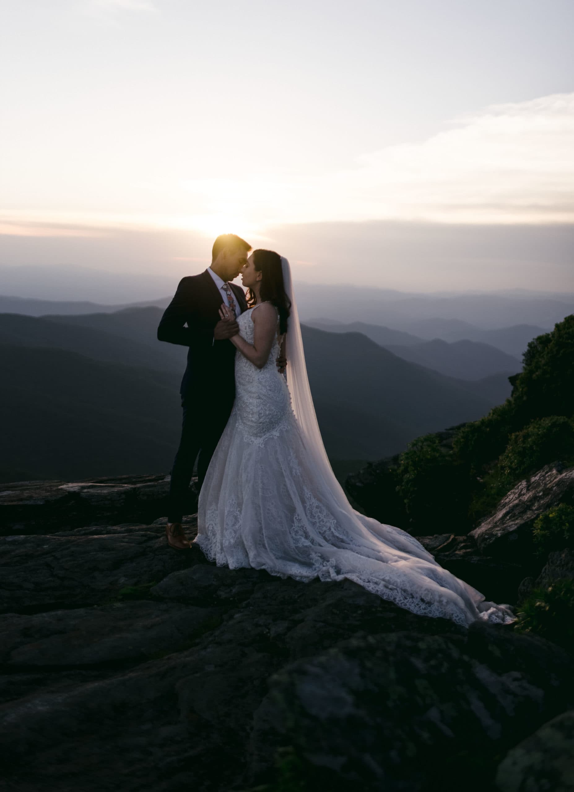 A couple that purchased an elopement package gets married on top of the mountains.