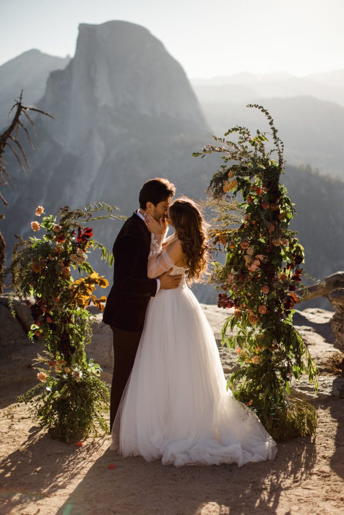 A couple sharing their first kiss that decided to elope in Yosemite.