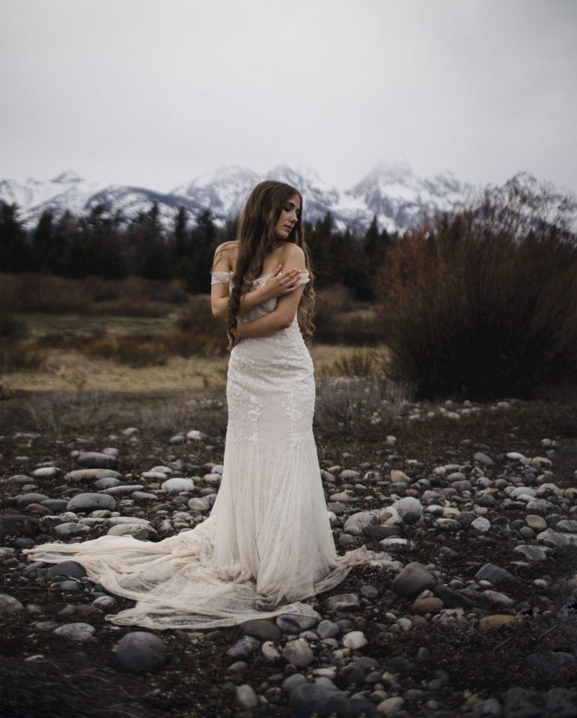 A bride at the Grand Tetons National Park after looking through Jackson Hole wedding venues.