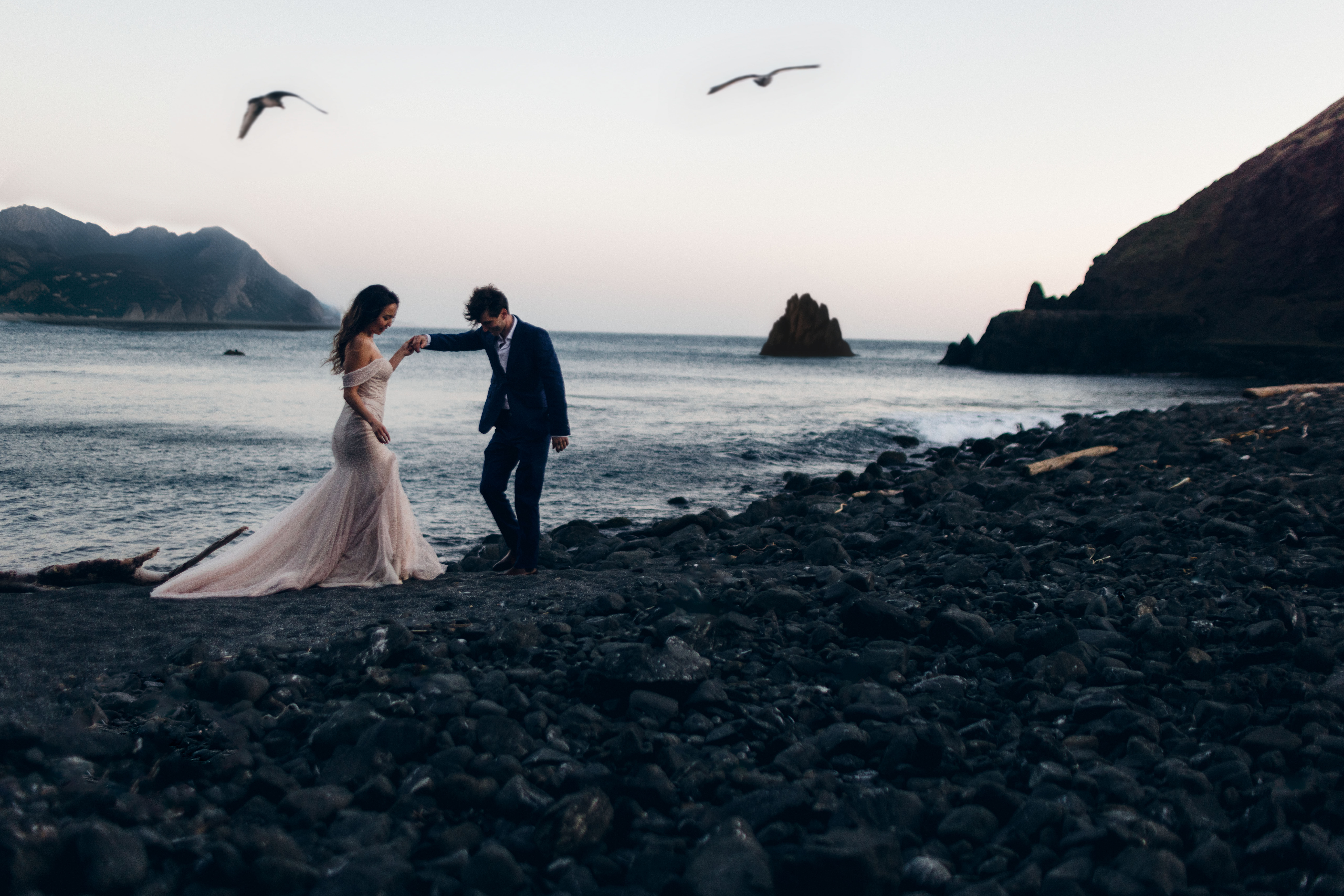A couple on the beach posing for an Oregon elopement guide.